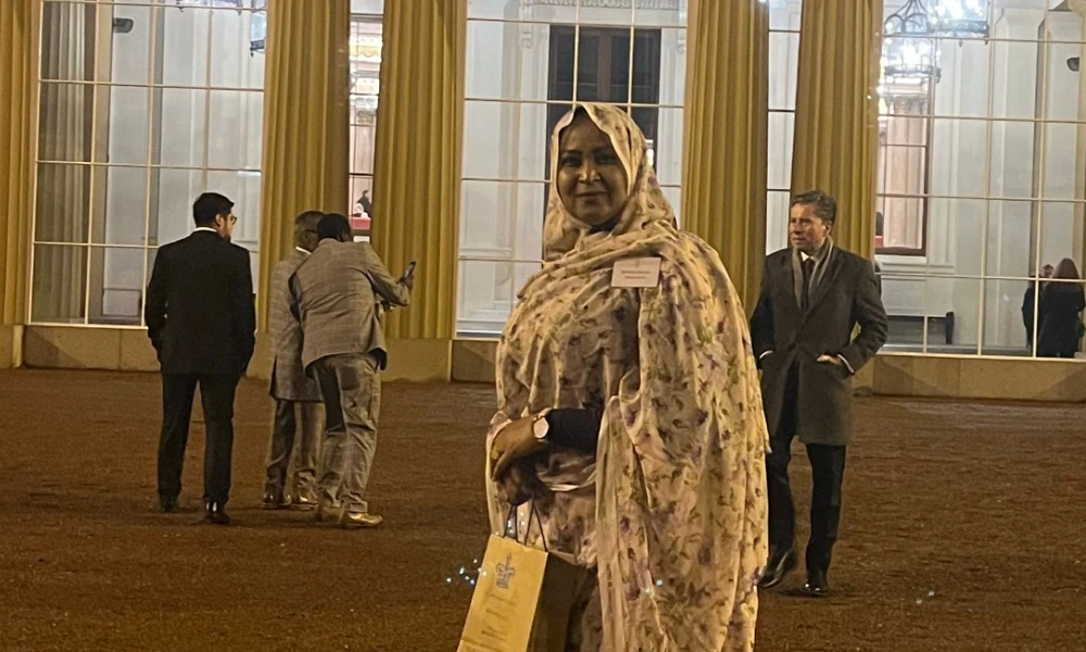 Maha Khalifa standing in the grounds of Buckingham Palace