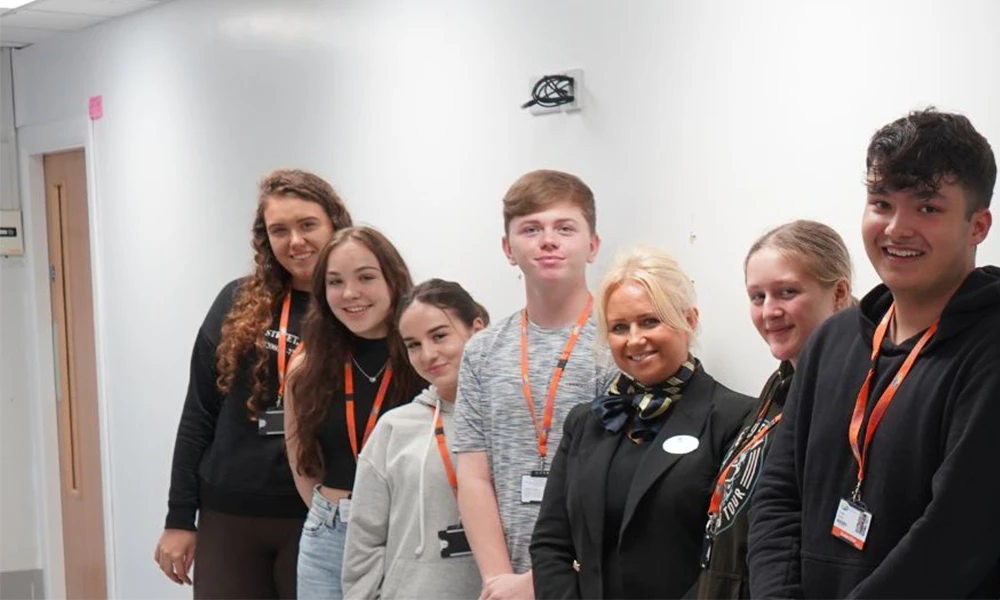 Travel and Tourism students standing next to Leanne Rose