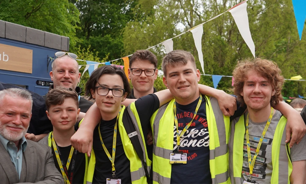 Construction students having picture taken in Dementia village