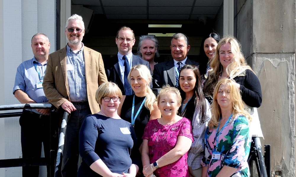 Wirral Met and Edge Hill staf having picture taken outside Hamilton Campus