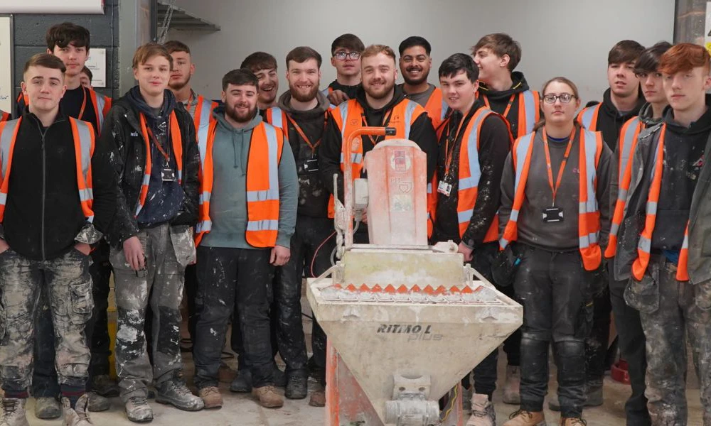 Plastering apprentices standing together during training day