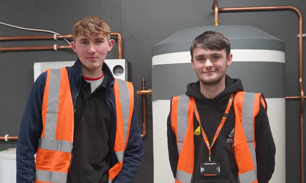Two Construction apprentices standing in workshop