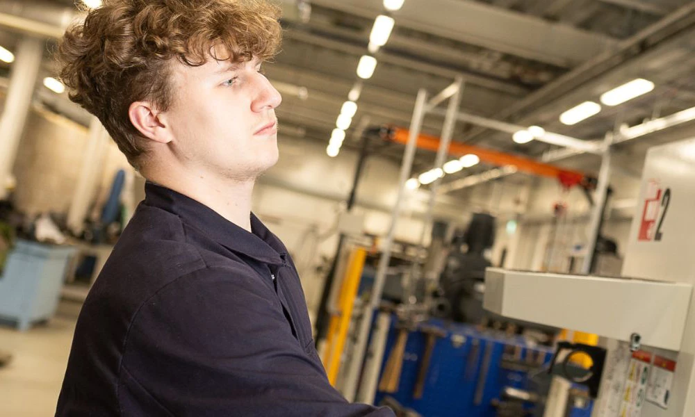 Engineering student using machinery at Twelve Quays campus