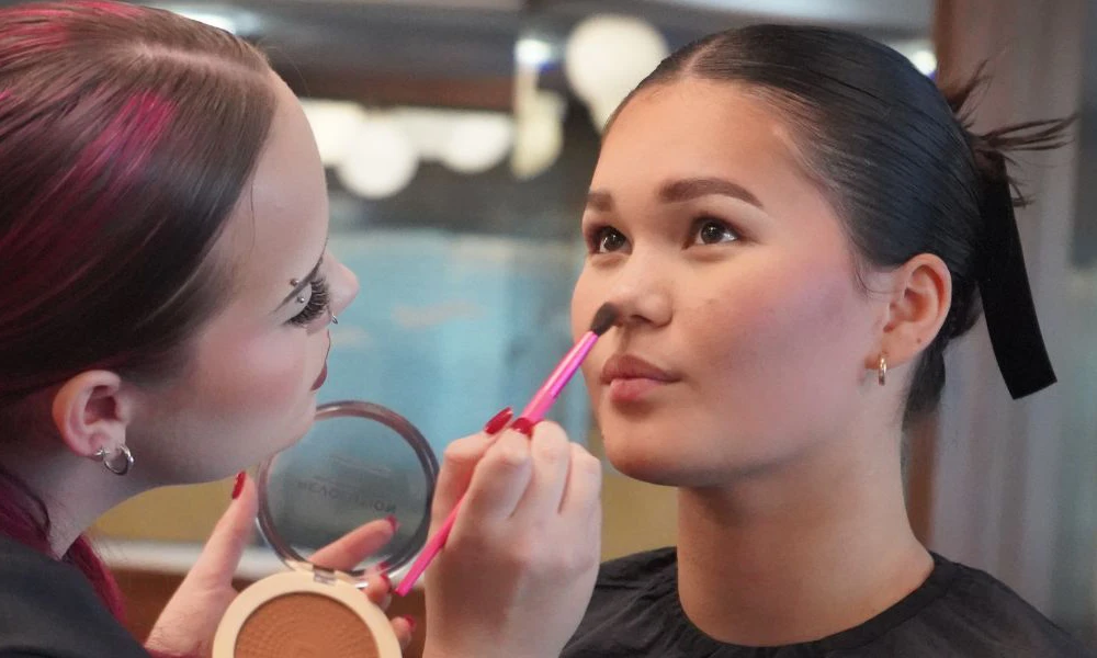 Wirral Met student doing makeup during Liverpool Fashion Week
