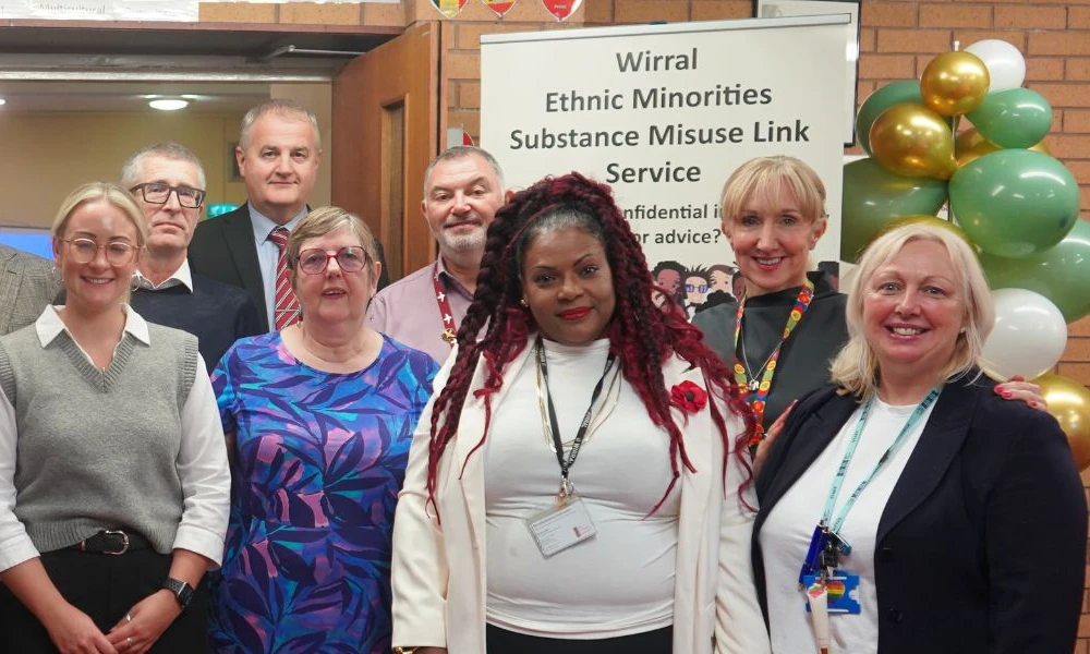 Wirral Met ESOL department staff standing with local community