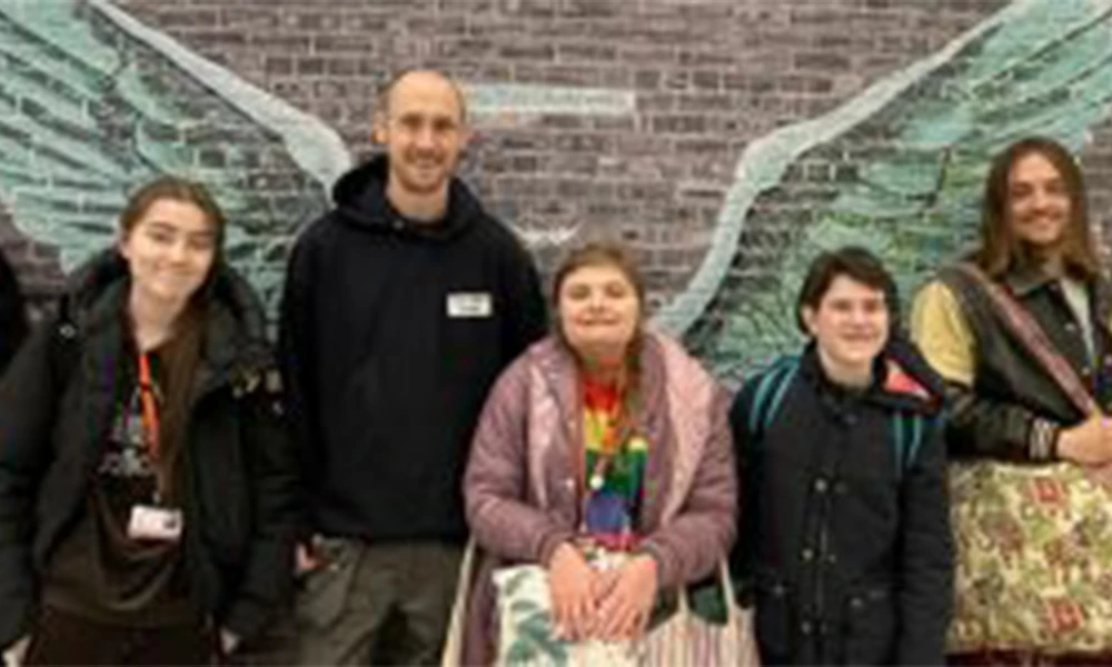 Paul Curtis standing alongside students