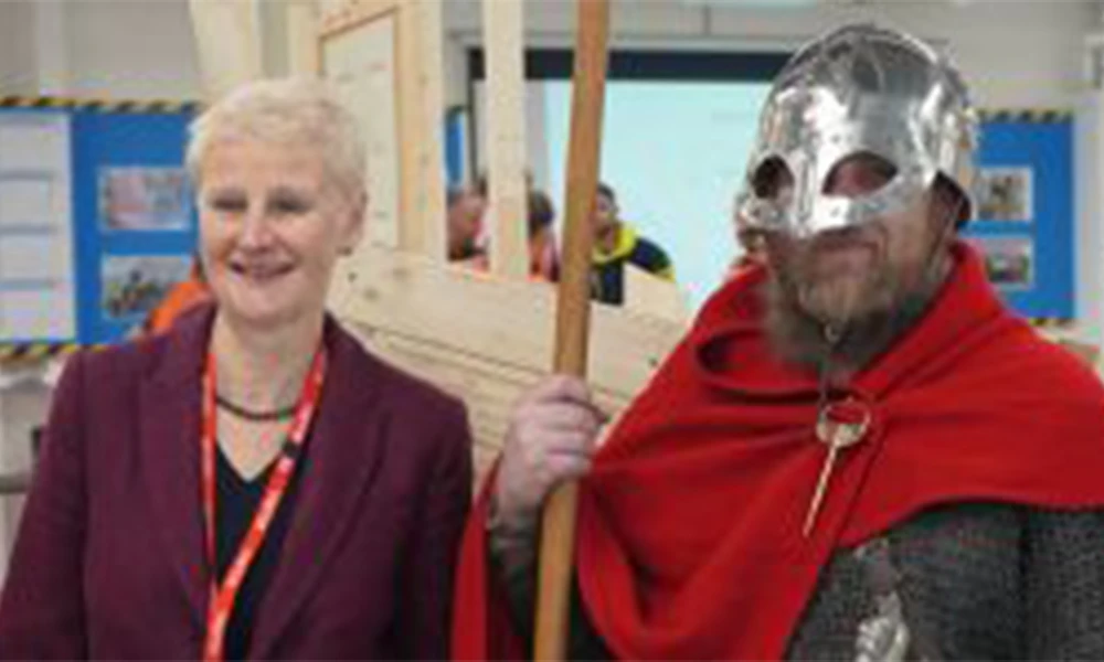 Visitor Shelagh standing next to man in Viking attire