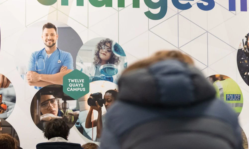 Wirral Met student seated at Twelve Quays breakout area