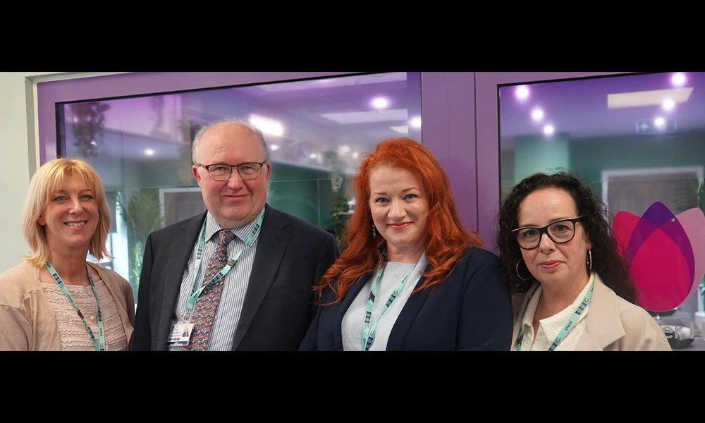 Four Wirral Met members of staff standing beside the new Tomorrow's Women Hair and Beauty salon