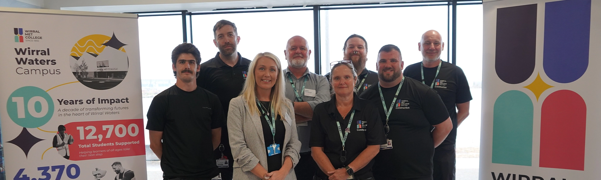 Construction tutors having a picture taken together during the Wirral Waters ten year anniversary