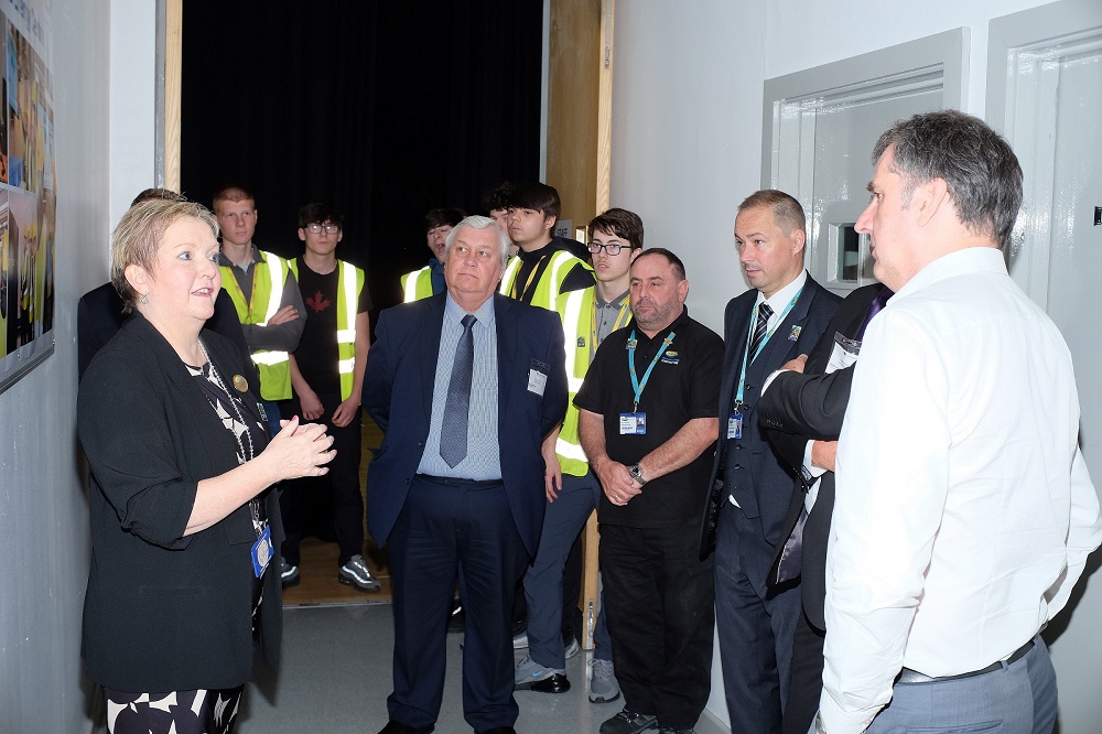 Principle of Wirral Met College Sue Higginson standing in a corridor with Metro Mayor Steve Rotheram