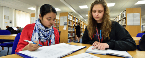 Two girls studying in the Library at Wirral Met College