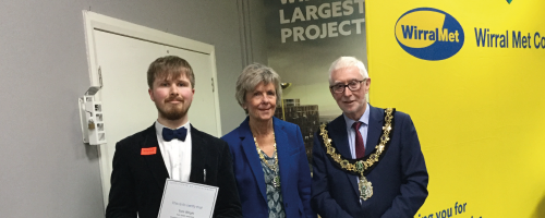 The Mayor and Mayoress of Wirral Council with Wirral Met College supported intern stood in front of branded yellow banner